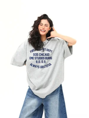 Close-up front view of women’s oversized gray Chicago firefighter inspired lettering streetwear T-shirt