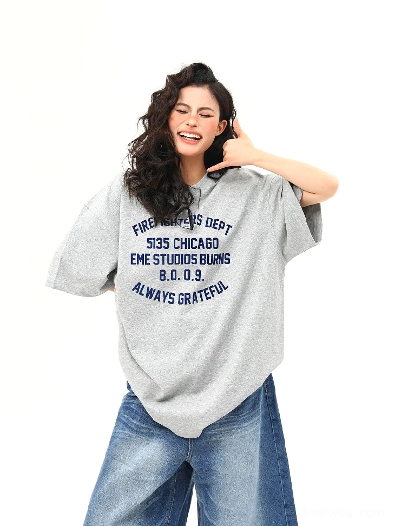 Close-up front view of women’s oversized gray Chicago firefighter inspired lettering streetwear T-shirt