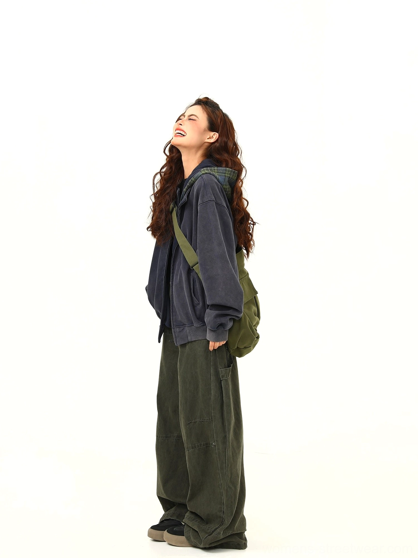 Side view of a women's oversized navy hooded sweatshirt jacket with relaxed drop-shoulder streetwear proportions