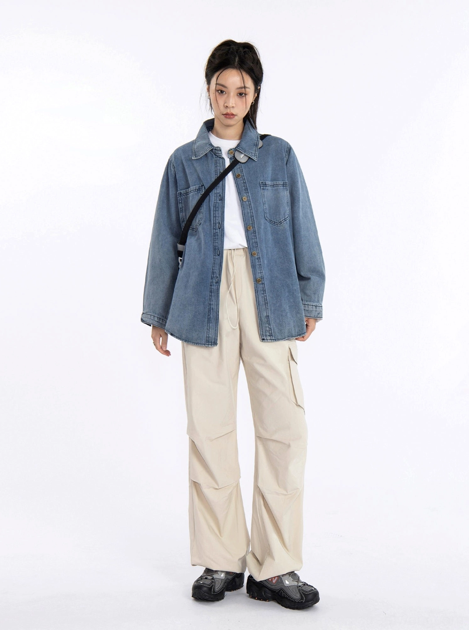 Women's oversized washed blue denim shirt jacket featuring a classic collar, long sleeves, and versatile casual layering design