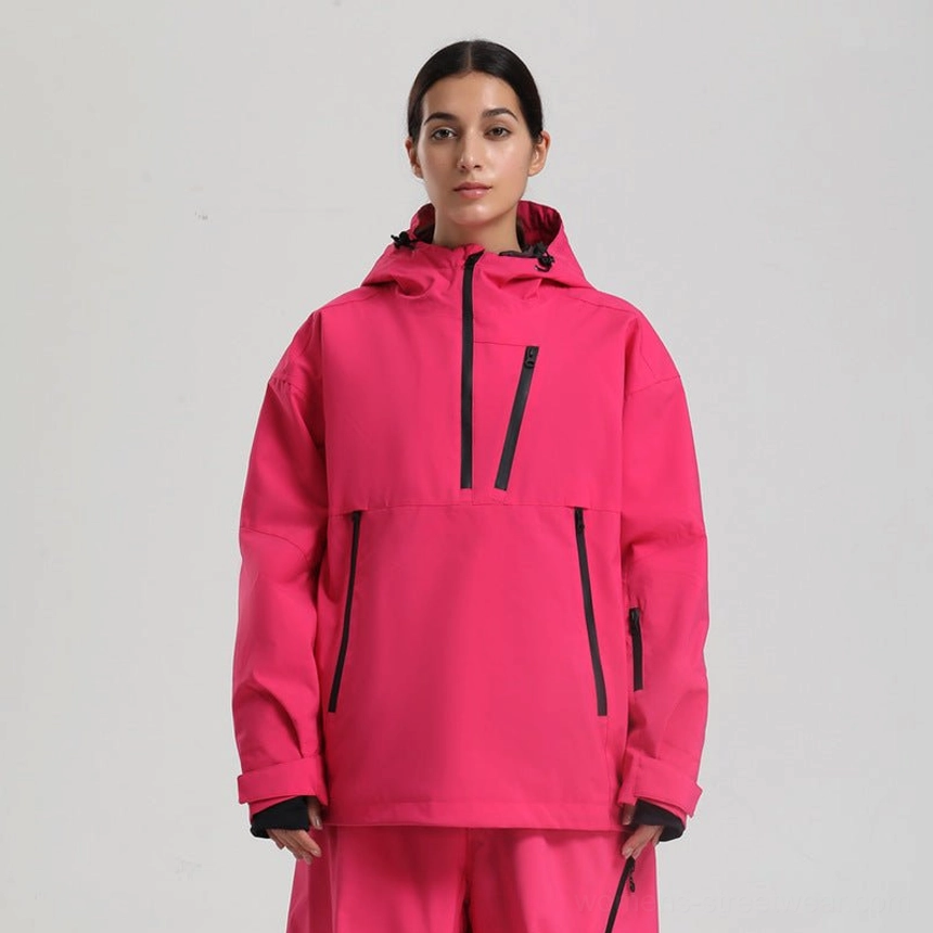 Women’s oversized waterproof ski anorak jacket in hot pink with contrast black zippers and matching snow pants front view