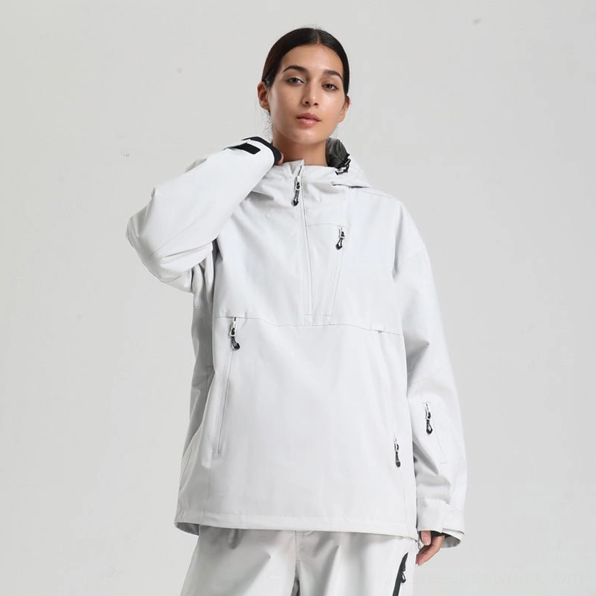 Women’s oversized waterproof ski anorak jacket in off white with adjustable hood and black zip pockets front three quarter view