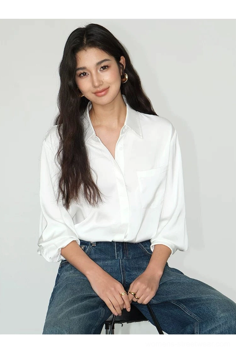 Women's pearl white relaxed satin shirt with rolled cuffs and chest pocket styled with high waisted jeans