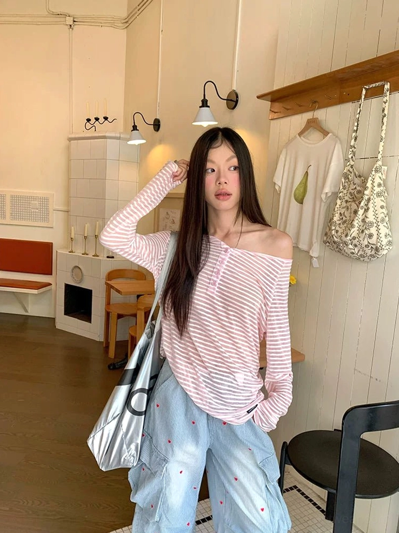 Front view of women’s pink and white striped off-shoulder henley long sleeve tee with relaxed streetwear fit