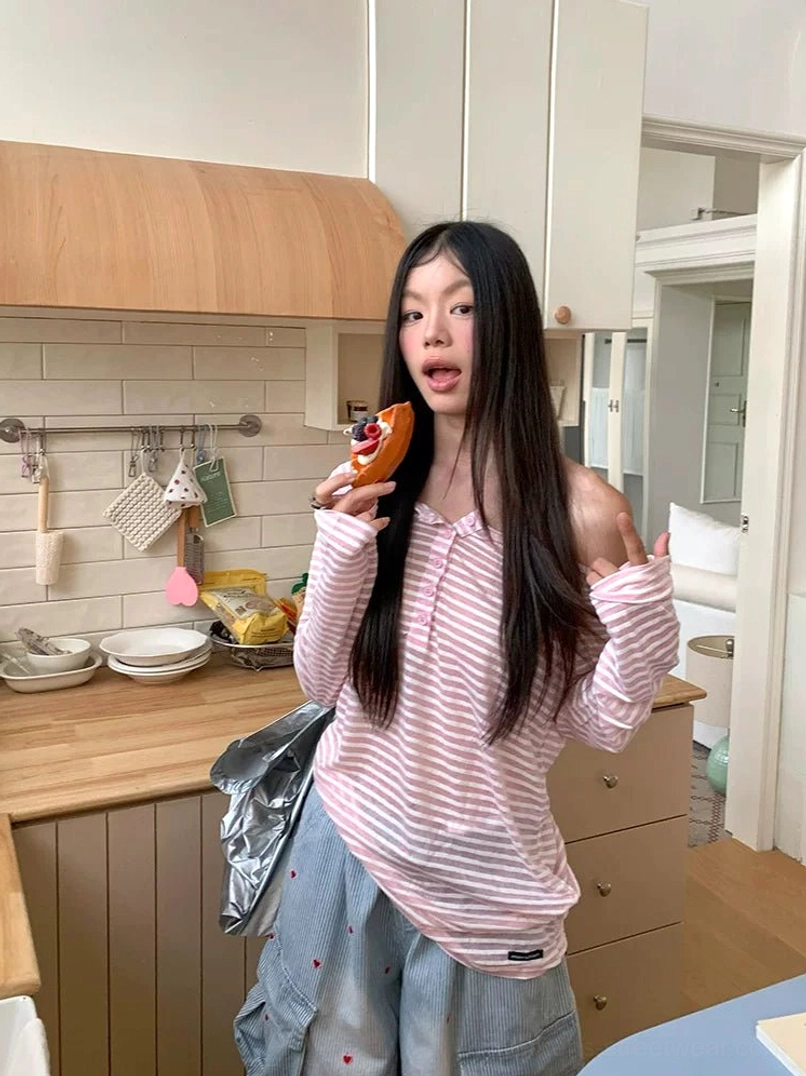 Pink and white striped off-shoulder henley long sleeve tee for women styled in a casual kitchen setting