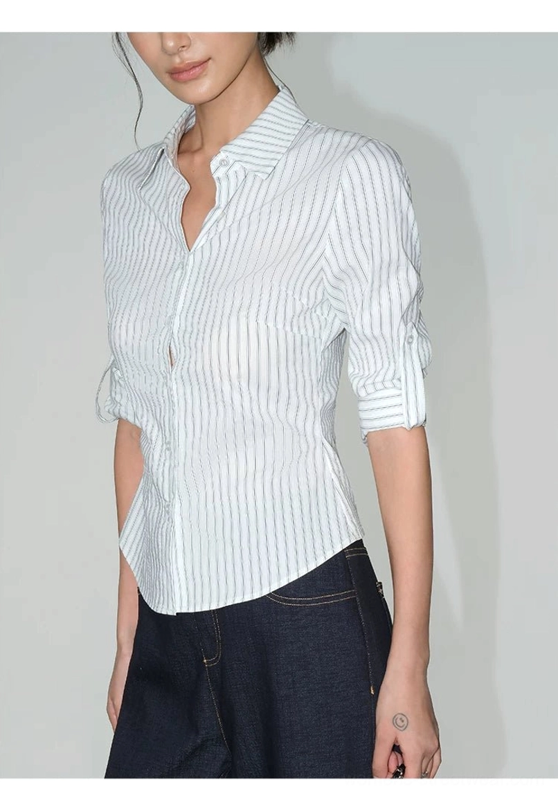 Women's pinstripe shirt with structured collar, long sleeves, curved hem, and contemporary streetwear styling
