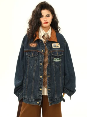 Front view of women's dark blue racing patch denim jacket with contrasting corduroy collar and button-down streetwear design