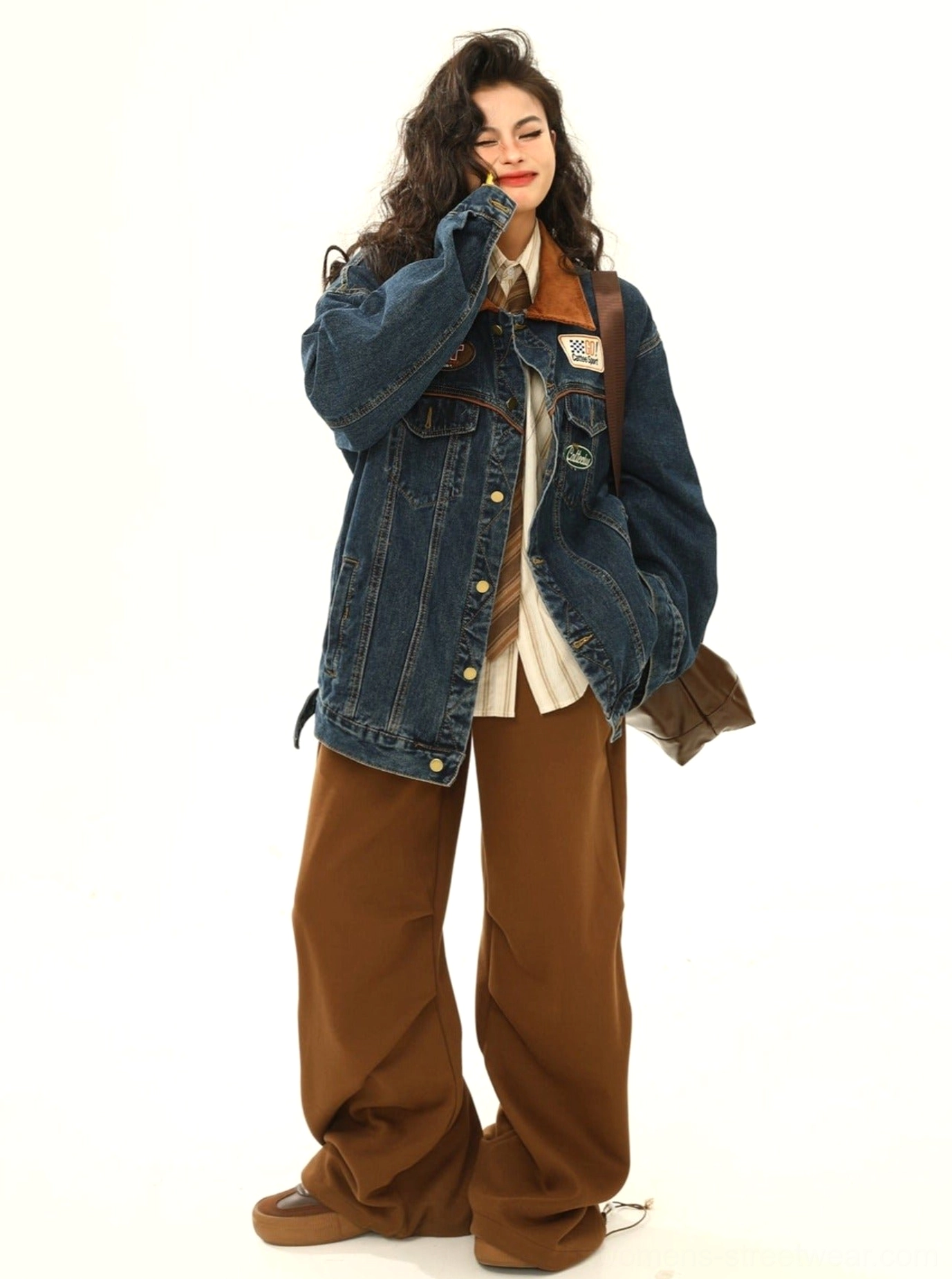 Full-body side view of women's racing patch denim jacket with retro racing patches, corduroy collar, and relaxed streetwear silhouette