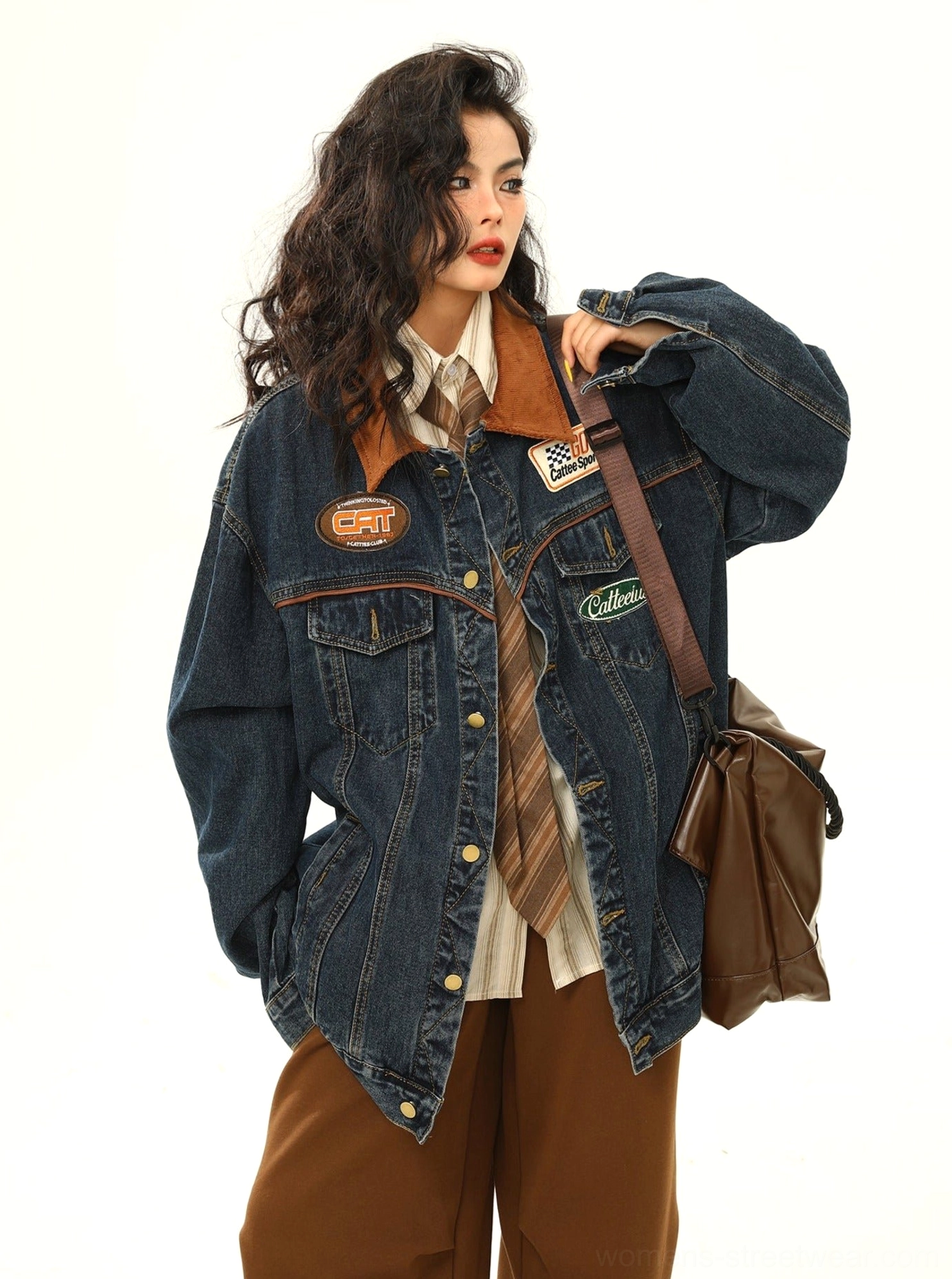 Side front detail of women's racing patch denim jacket with hand pocket, adjustable hem, and casual motorsport streetwear styling