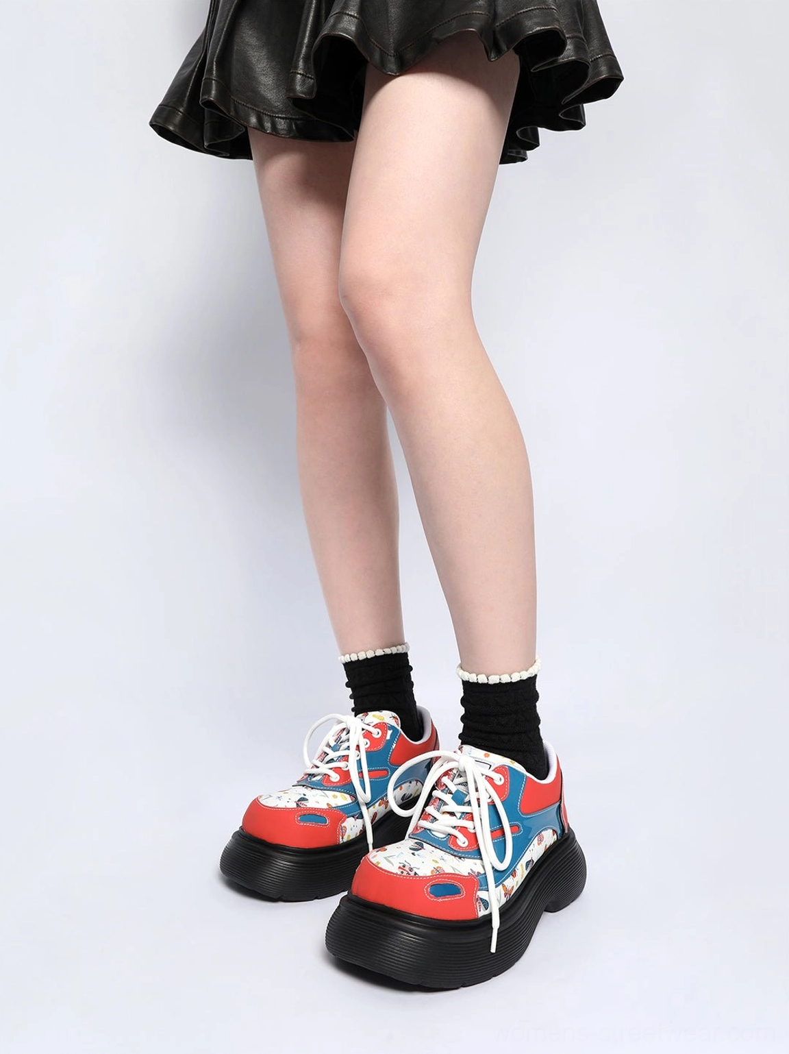 Women's chunky red butterfly print platform derby shoes styled with a black mini skirt