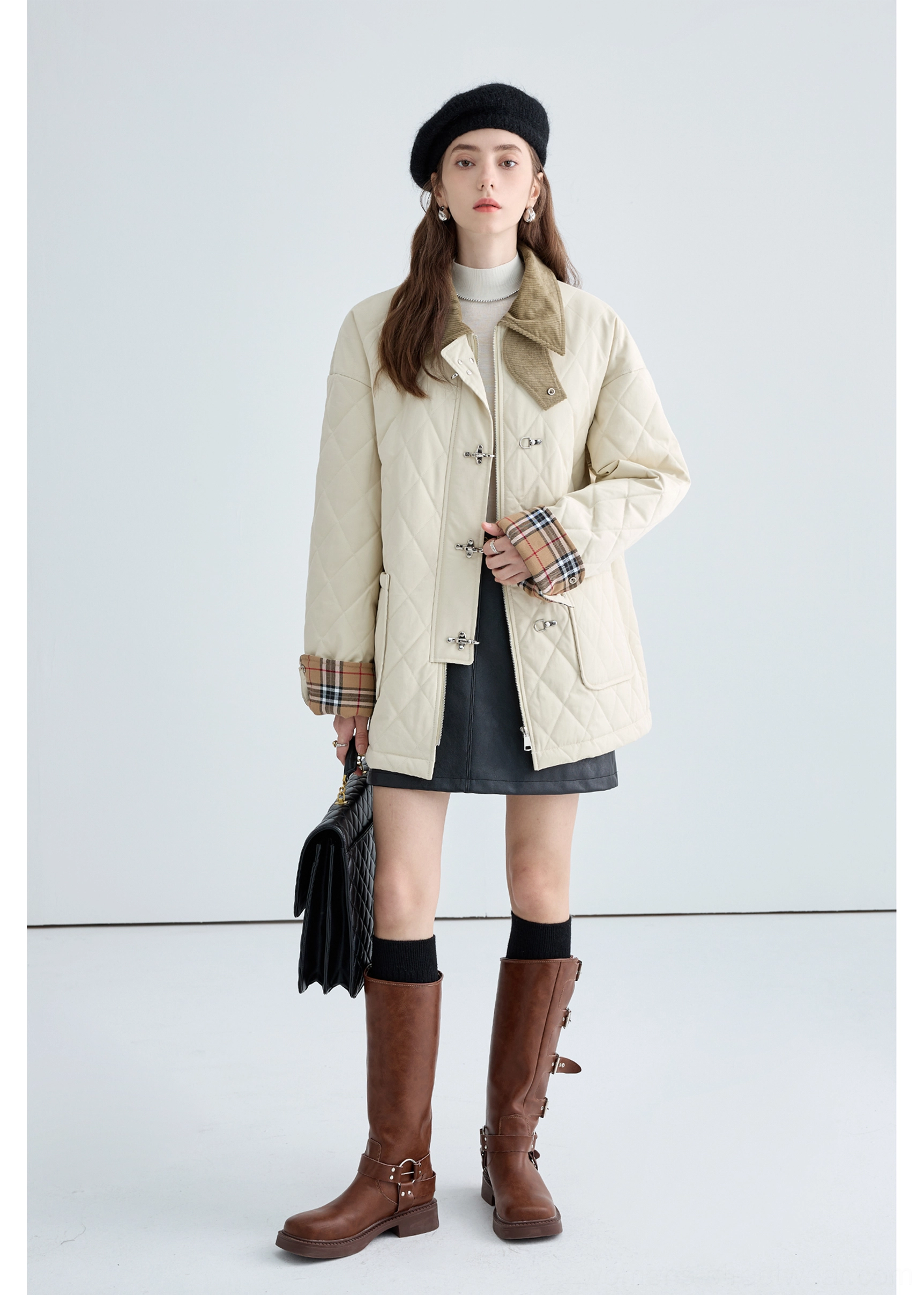 Women's relaxed fit beige quilted cotton jacket showing long sleeves, plaid cuffs and metal buckle closure design