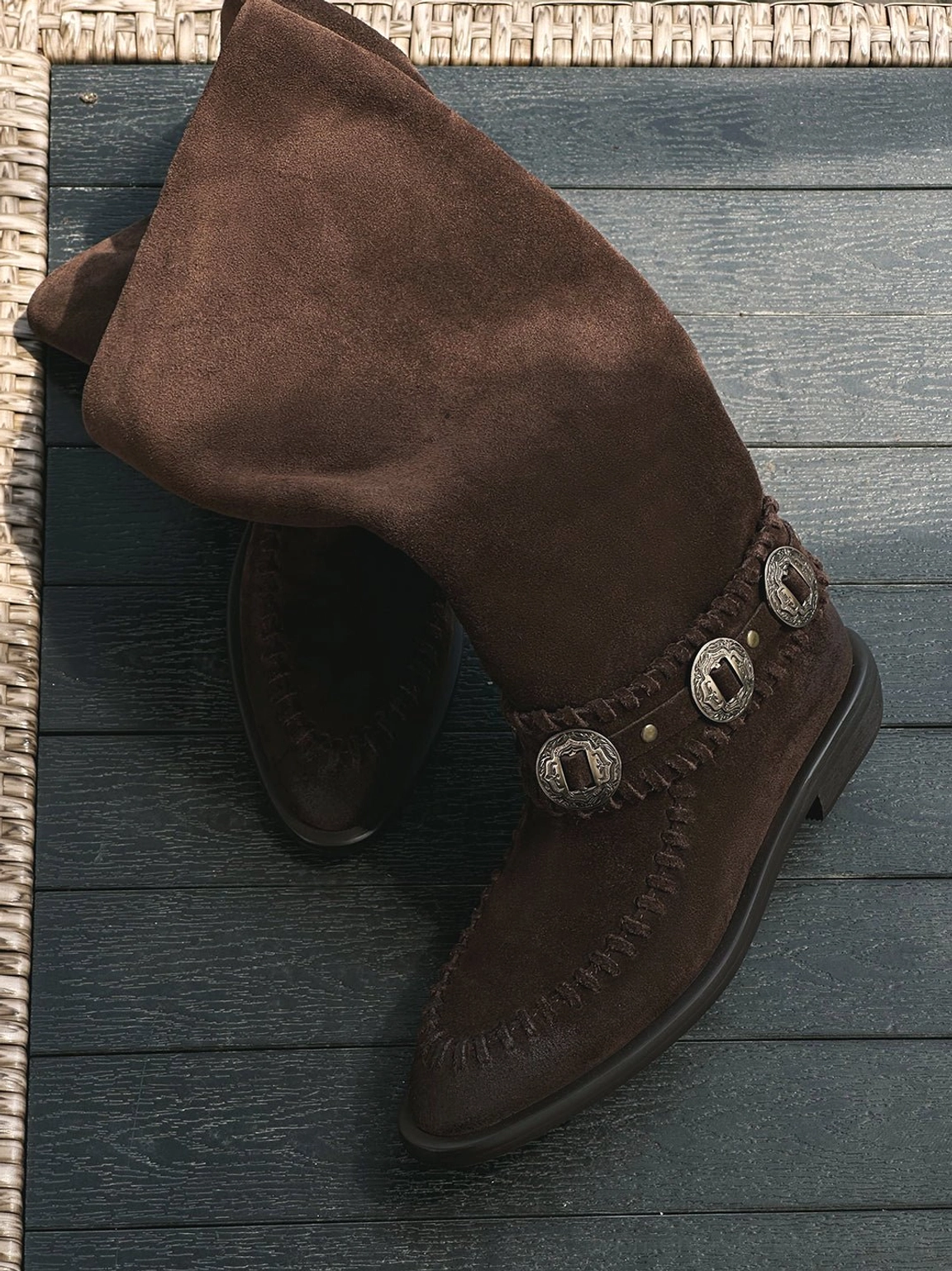 Relaxed-fit women's suede western knee-high boots with slouchy shafts, metal buckle details, and vintage streetwear styling