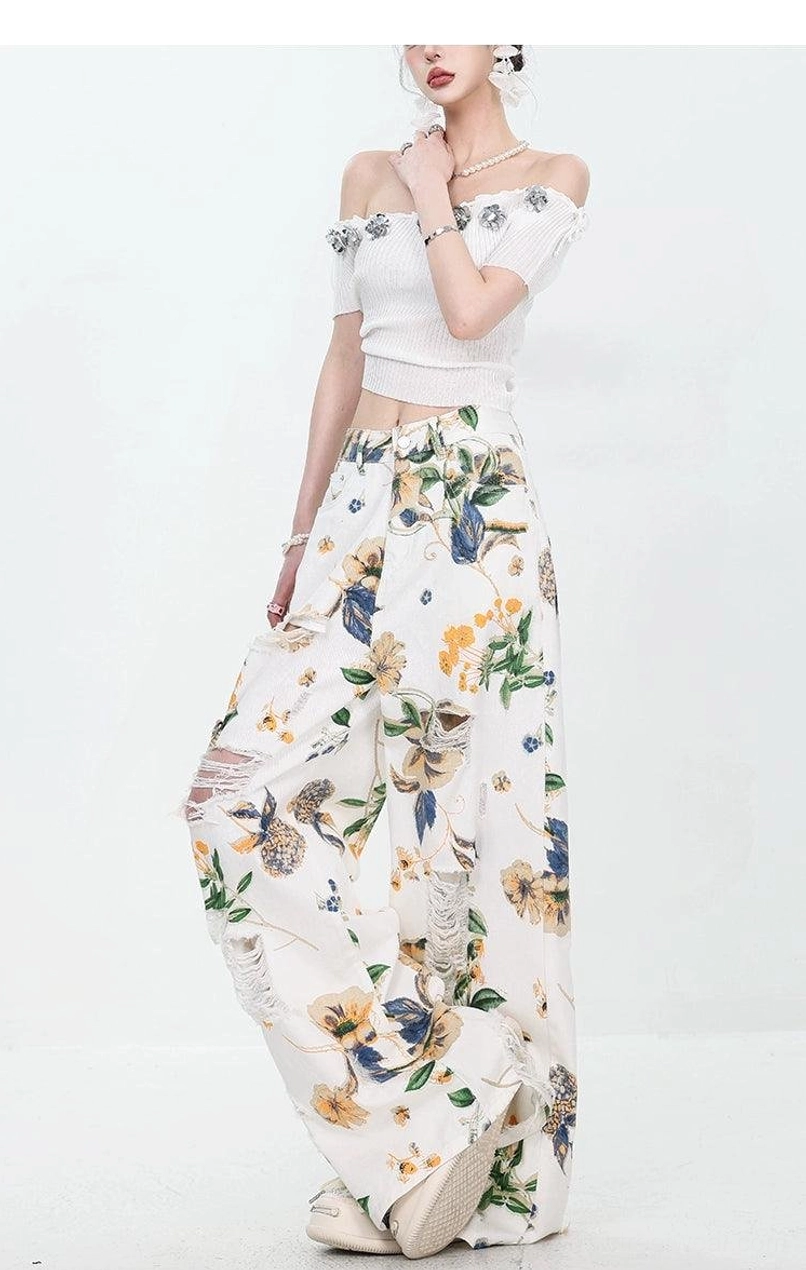 Women's relaxed wide-leg floral denim jeans with raw distressed details and casual styling