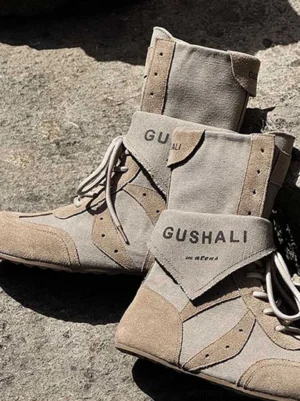 Top view of taupe retro boxing trainer boots with layered panels, lace-up closure and ankle straps