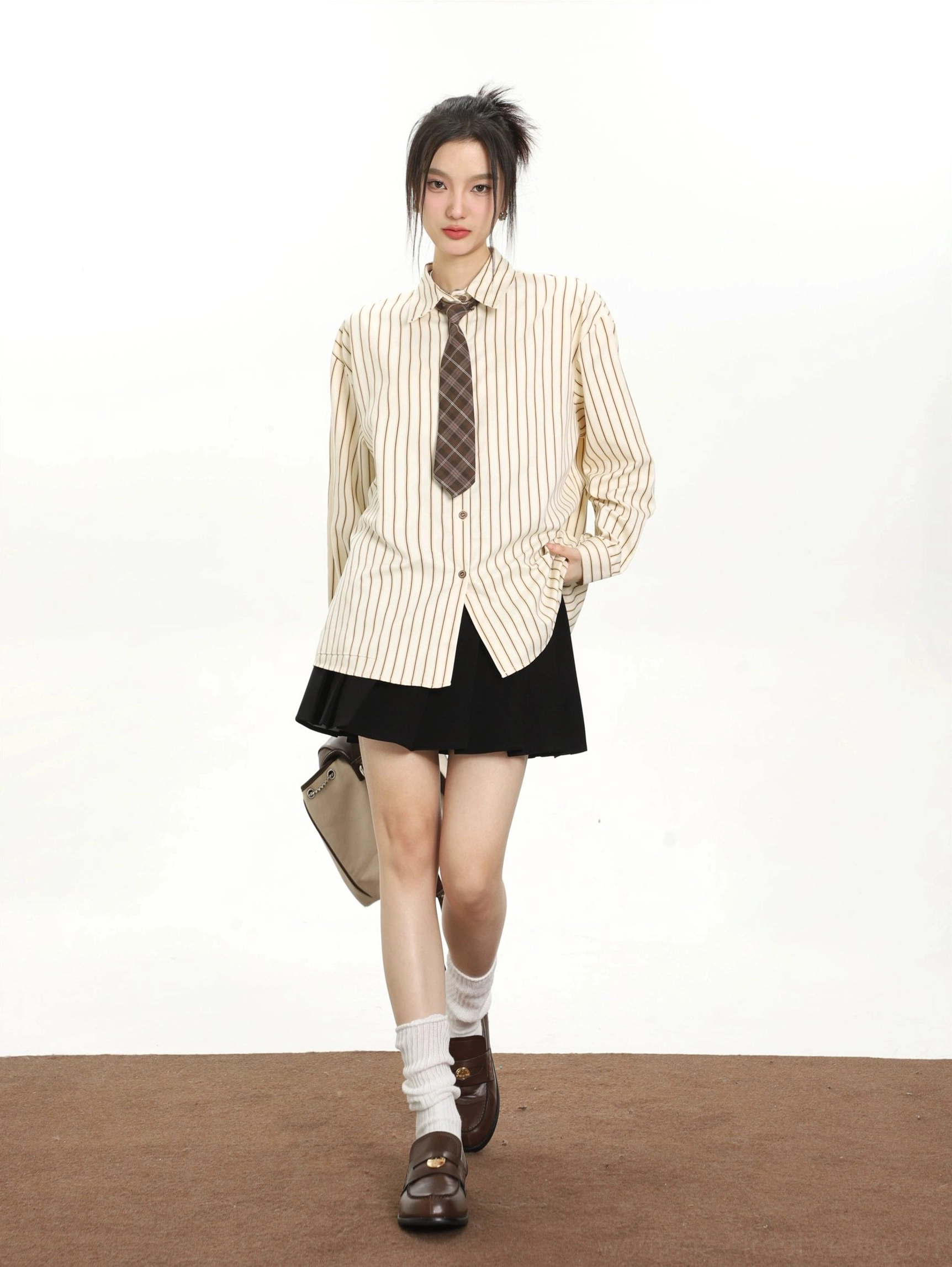 Khaki striped retro tie long sleeve shirt styled with a black pleated mini skirt for Seoul streetwear fashion