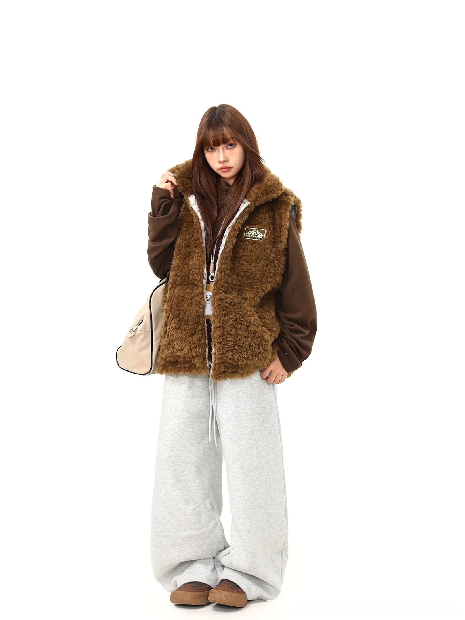 Women's solid brown teddy fleece side of the reversible sherpa vest in a relaxed front three-quarter view