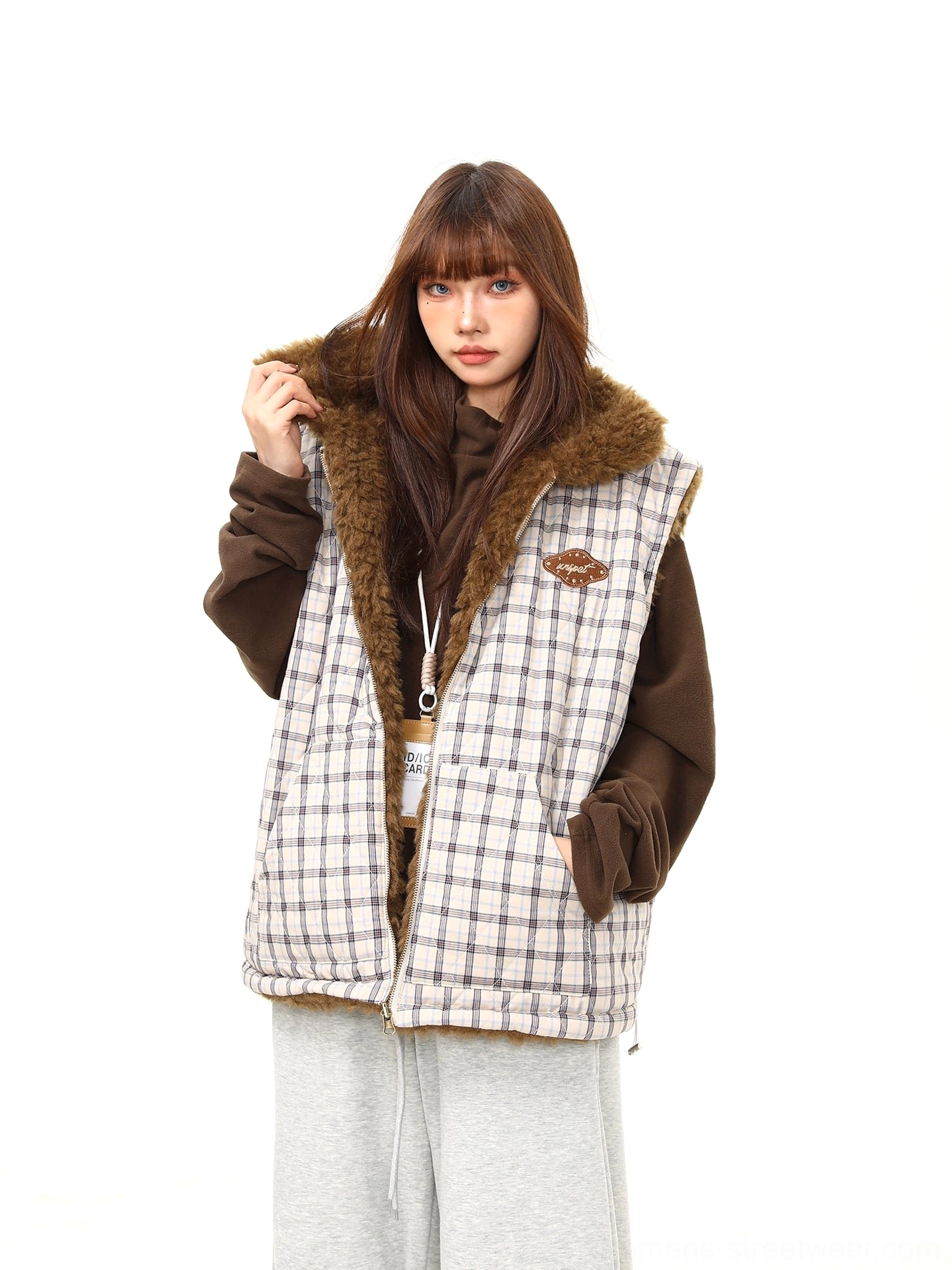 Women's reversible plaid sherpa vest close styling view highlighting the plush teddy collar and quilted check fabric