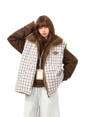 Women's reversible plaid sherpa vest with brown teddy fleece collar shown in a front three-quarter studio view