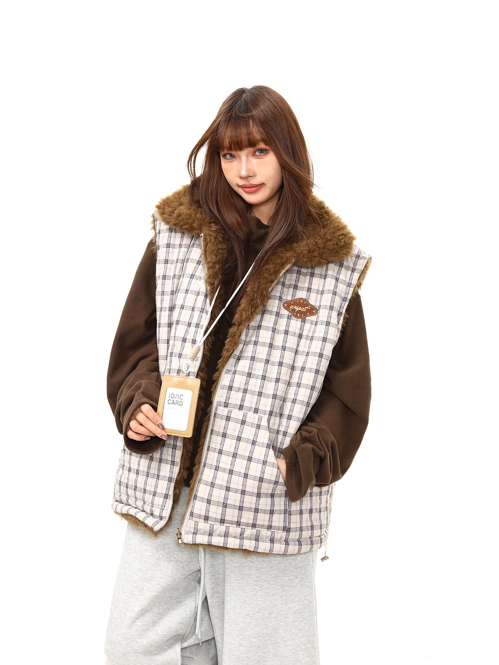 Side three-quarter view of women's quilted check sherpa vest with soft brown teddy fleece collar and chest badge