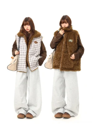 Women's reversible plaid sherpa vest showing both quilted check and solid brown teddy fleece wearable sides