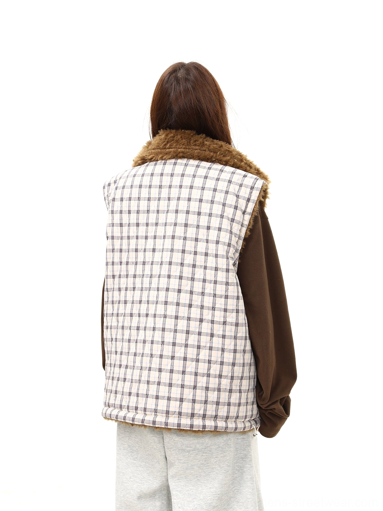 Women's reversible sherpa vest with plaid quilting, full front zipper, chest patch and soft fleece interior