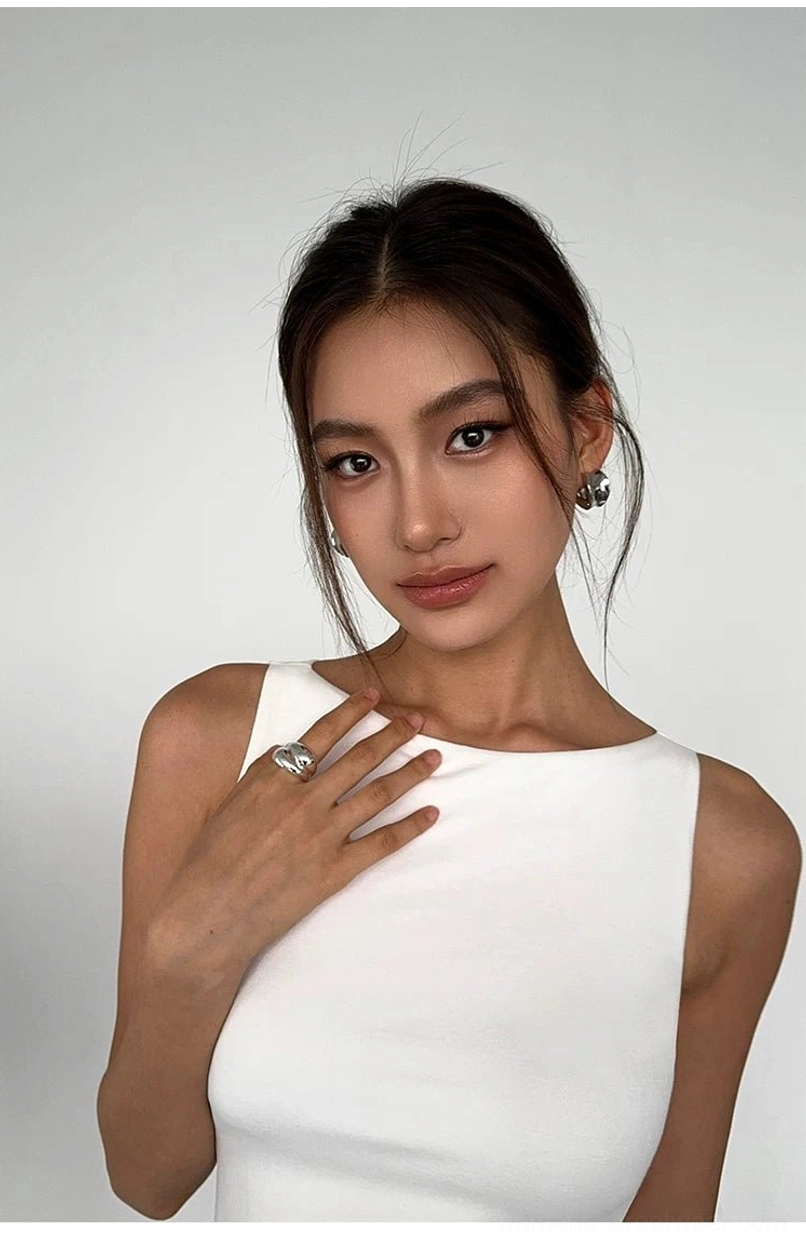 Close-up of white ribbed boat neck cropped tank top showing wide neckline fine knit texture and sleeveless slim fit