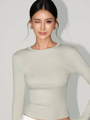 Light oat beige women's slim-fit ribbed long-sleeve crew neck tee with a waist-length hem and minimalist Seoul streetwear styling