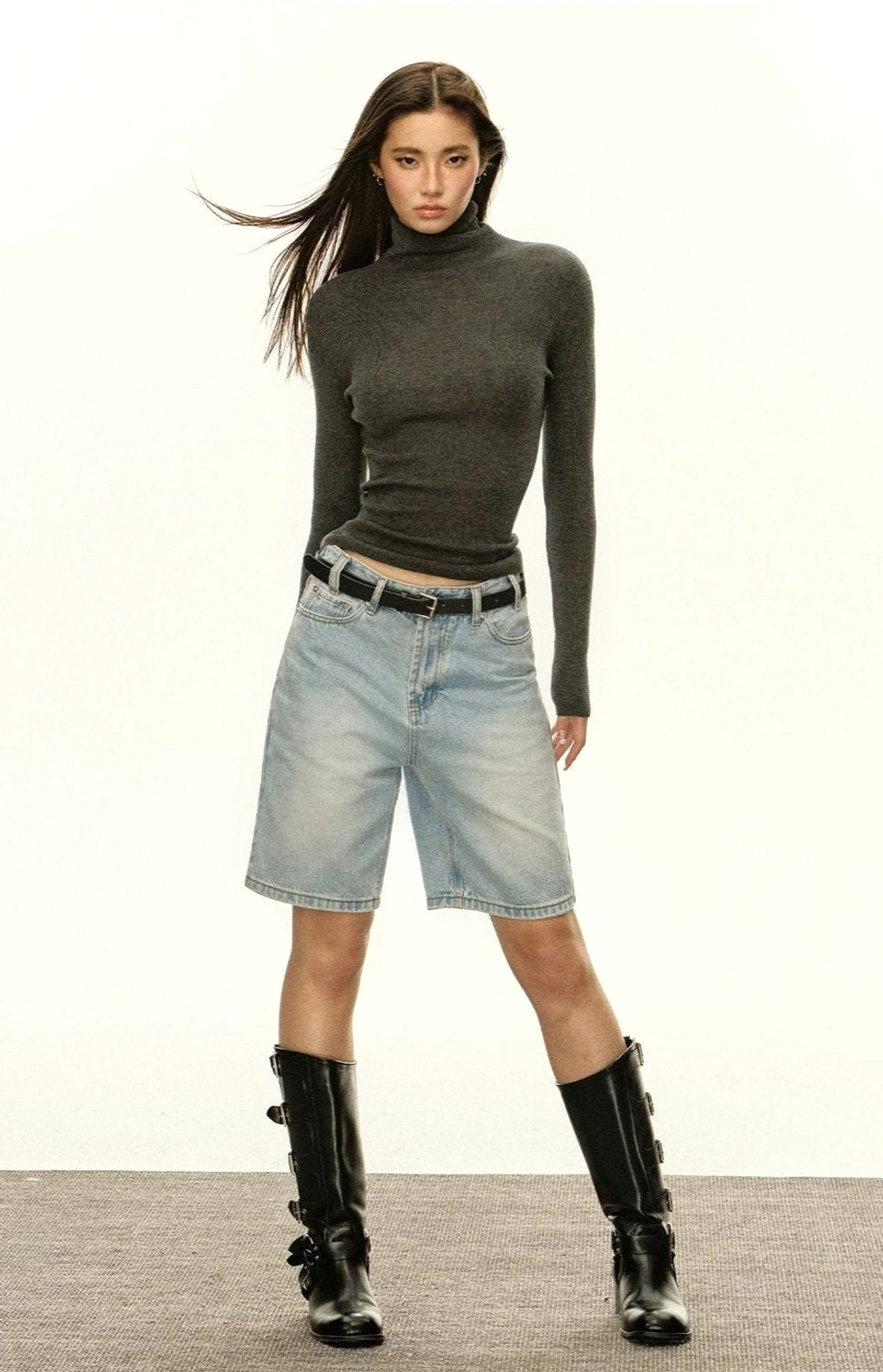 Heather grey women's fitted ribbed turtleneck sweater with belt denim shorts and boots