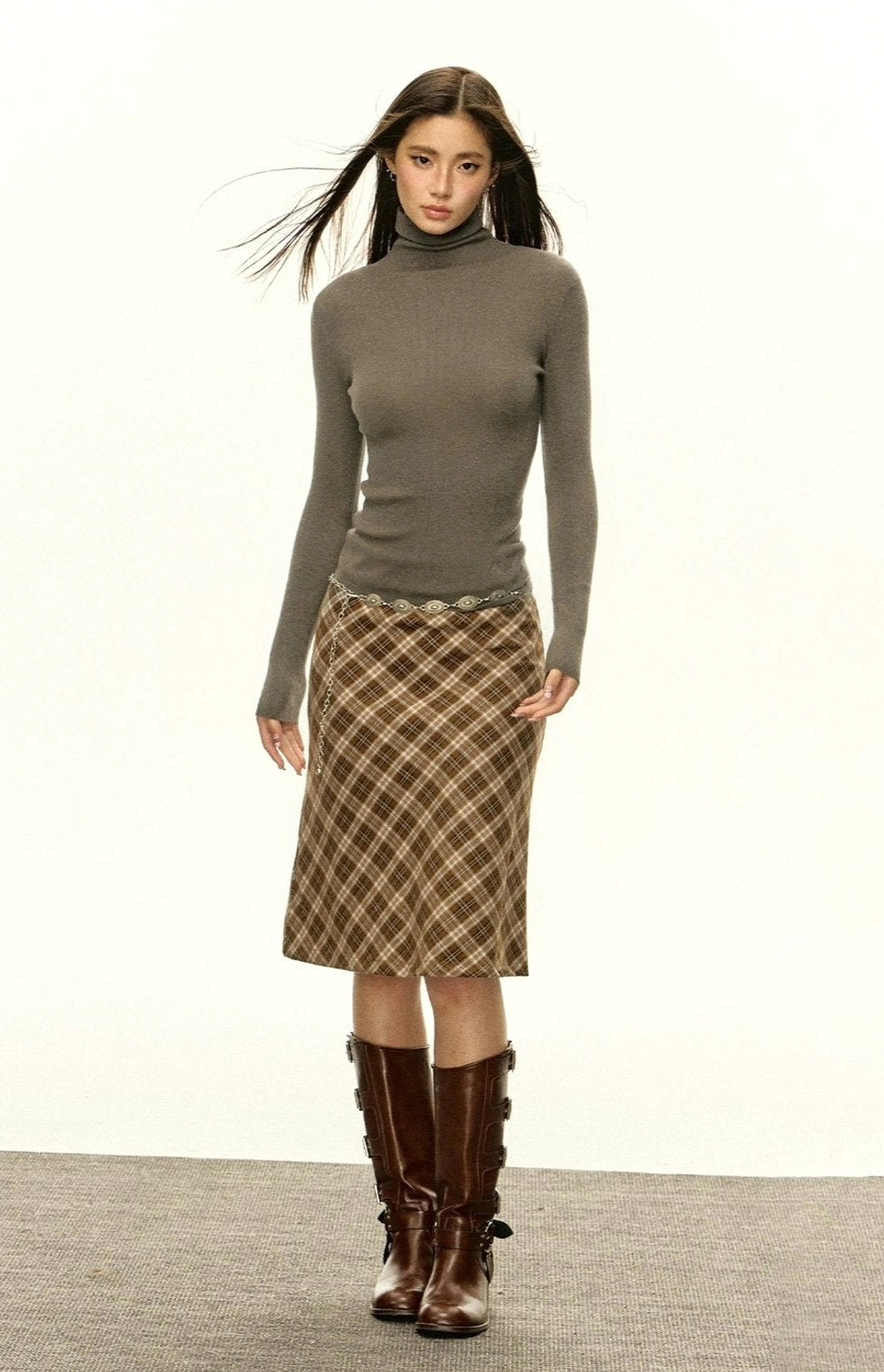 Heather grey slim-fit ribbed turtleneck knit sweater styled with plaid skirt and leather boots