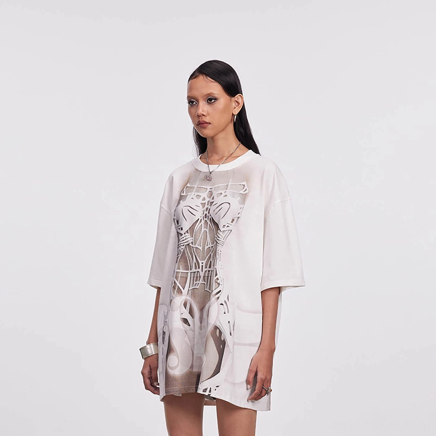 Three-quarter view of a women's oversized skeleton print mesh tee with brown anatomical graphic and relaxed drop sleeves