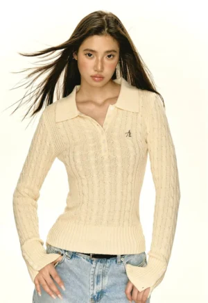 Beige women's slim cable knit half-button polo sweater styled with light blue jeans front view