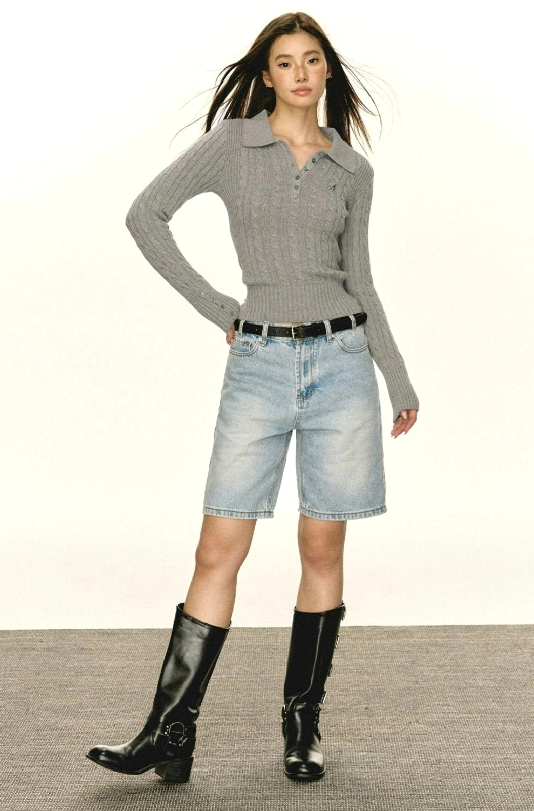 Women's cable knit polo sweater with slim fit silhouette and long sleeve cuff detail