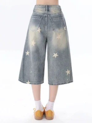 Women's star print wide leg cropped blue jeans back view showing faded wash and patch pockets