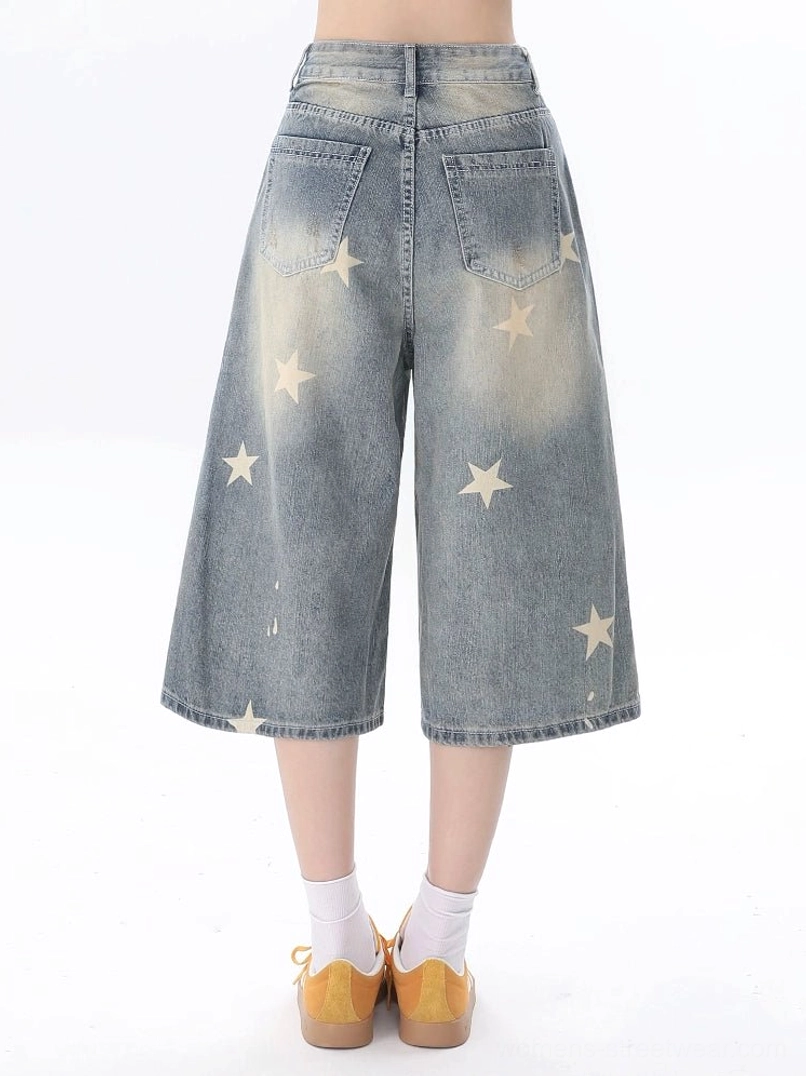 Women's star print wide leg cropped blue jeans back view showing faded wash and patch pockets