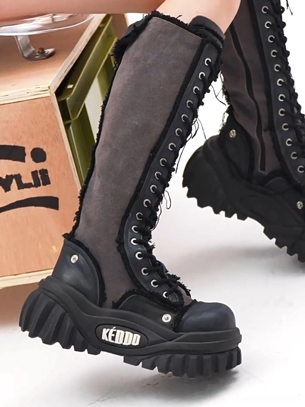 Women’s tall lace-up platform riding boots fashion detail view with raw frayed canvas trim