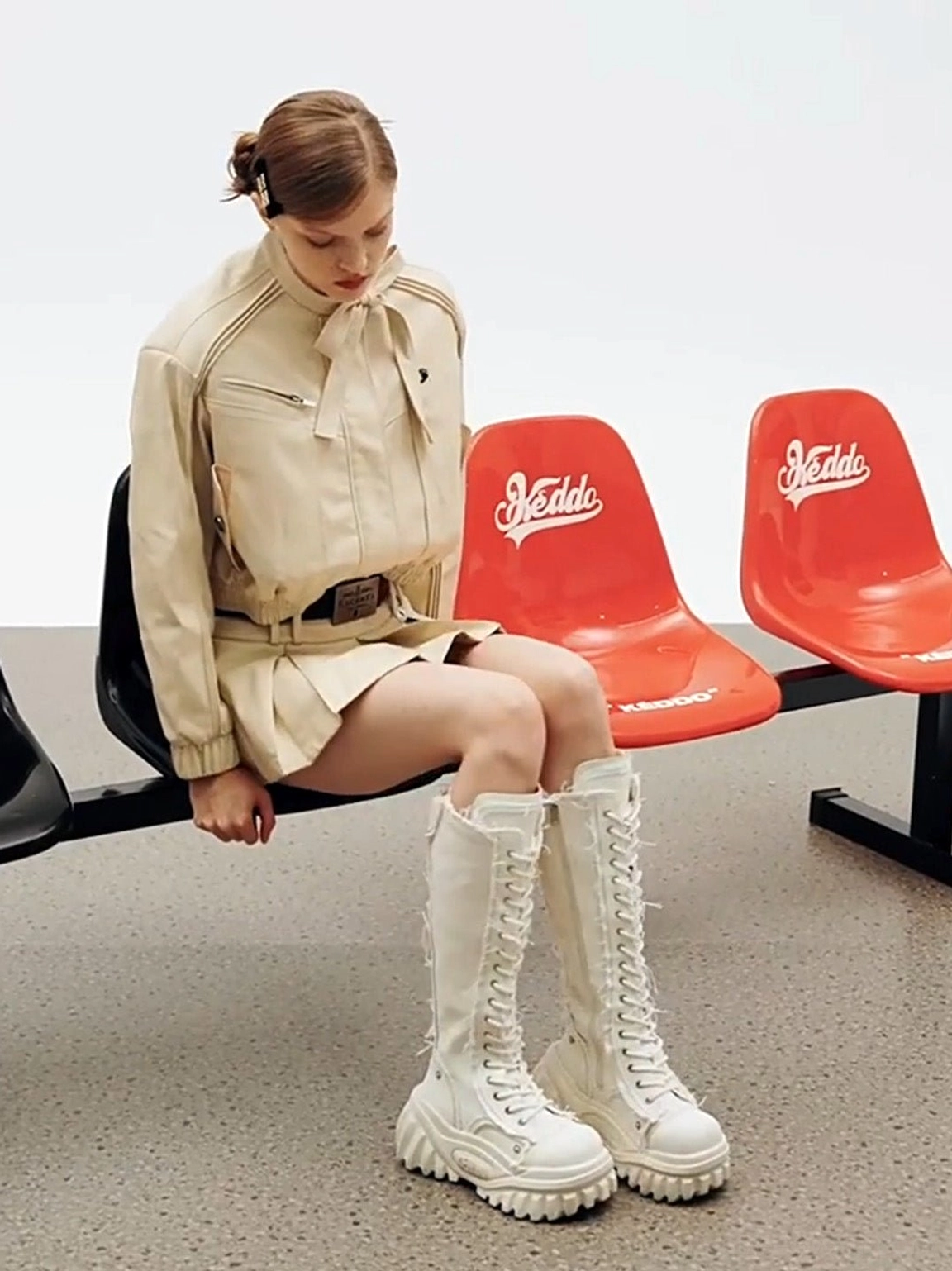 White tall lace-up platform riding boots styled with a beige Y2K preppy cropped suit outfit
