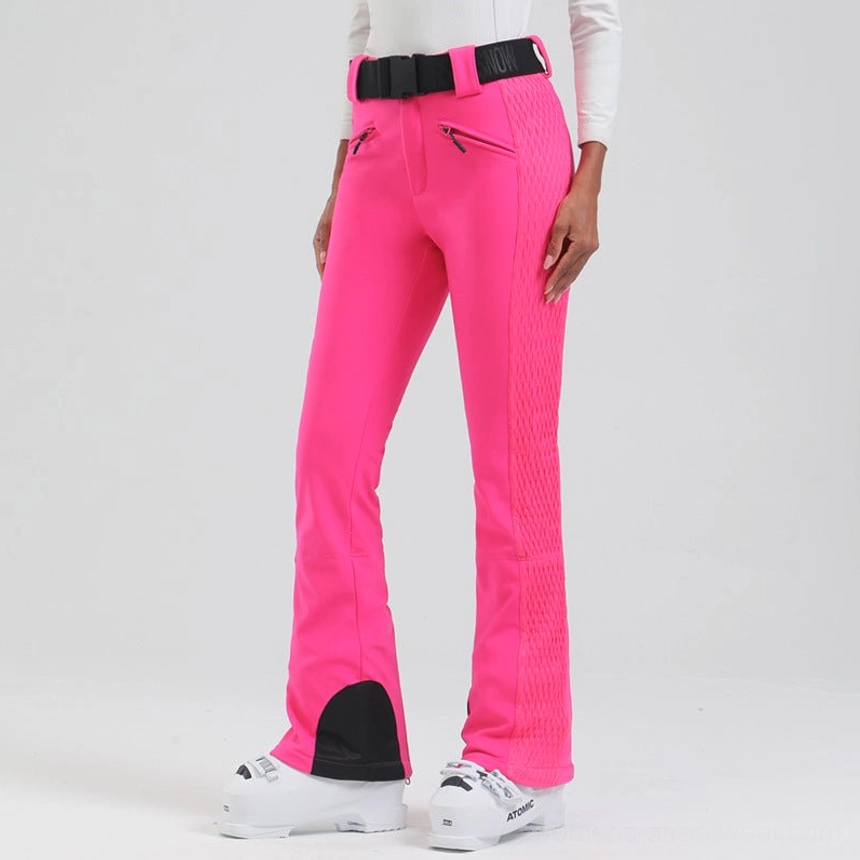 Women's technical flared ski pants with sculpted quilted side panels, secure zip pockets, stretch belt, and winter streetwear silhouette