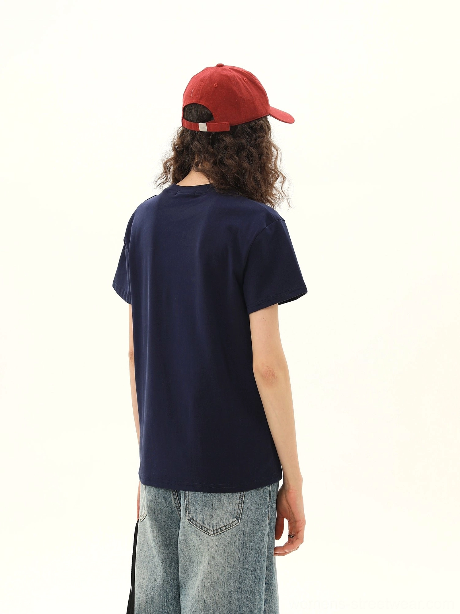 Back view of women's dark blue vintage varsity graphic tee with plain solid back and short sleeves