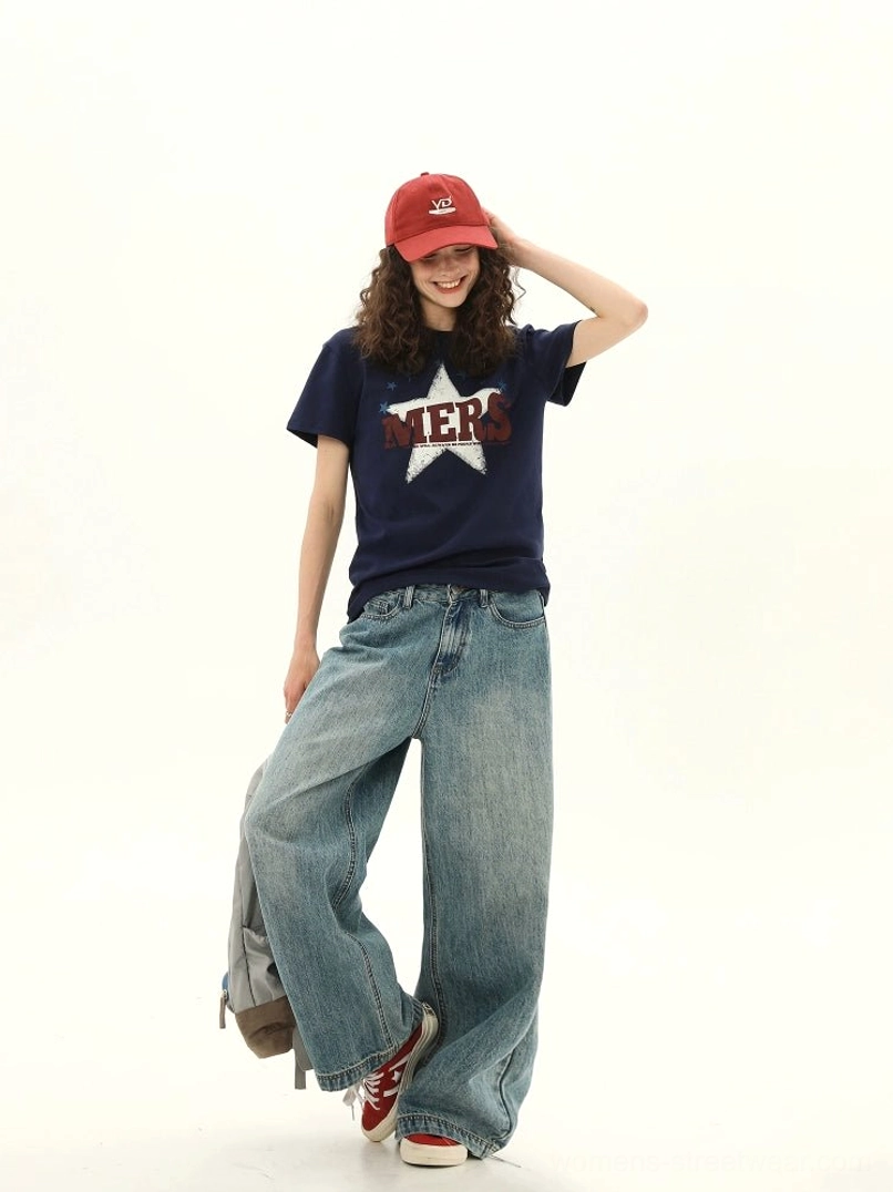 Dark blue MERS star varsity graphic T-shirt for women shown in a three quarter streetwear outfit with denim jeans