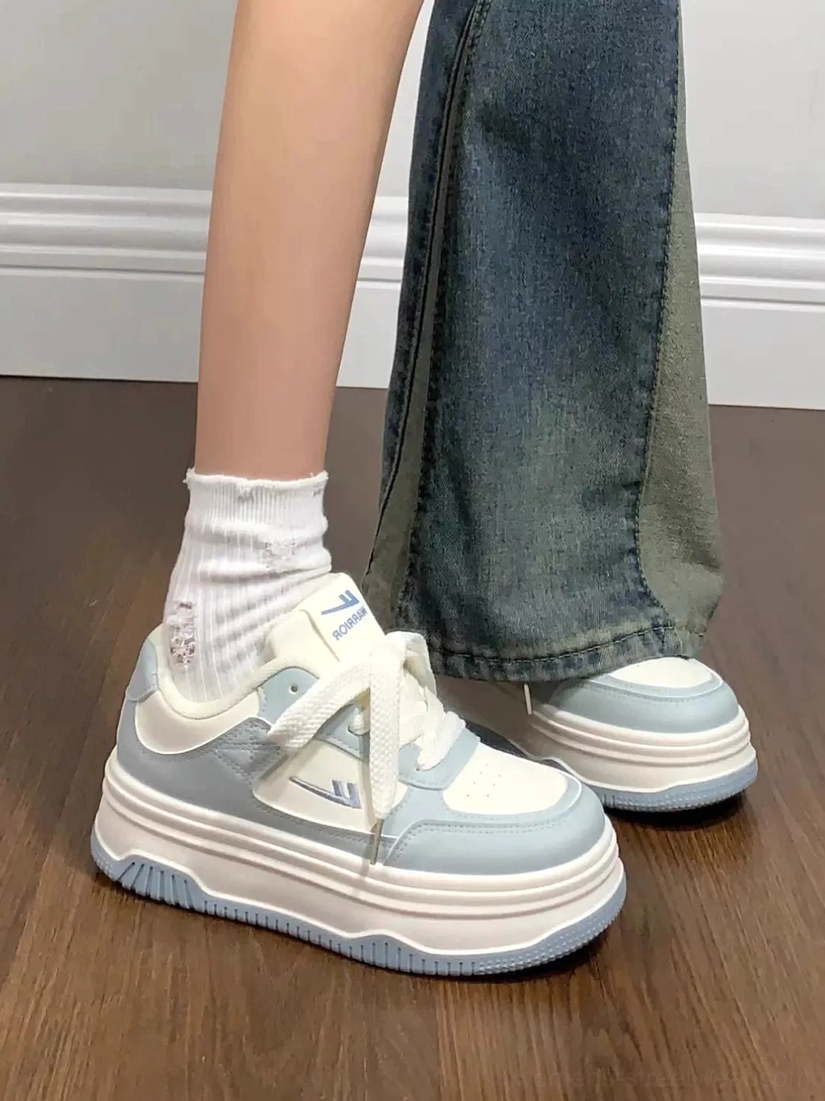 Side profile of women's white and blue contrast sole platform sneakers with cushioned chunky midsole