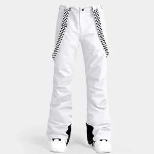 Women's white checkerboard ski snow pants shown from the front with graphic suspenders, flared legs, black ankle trim, and winter boots