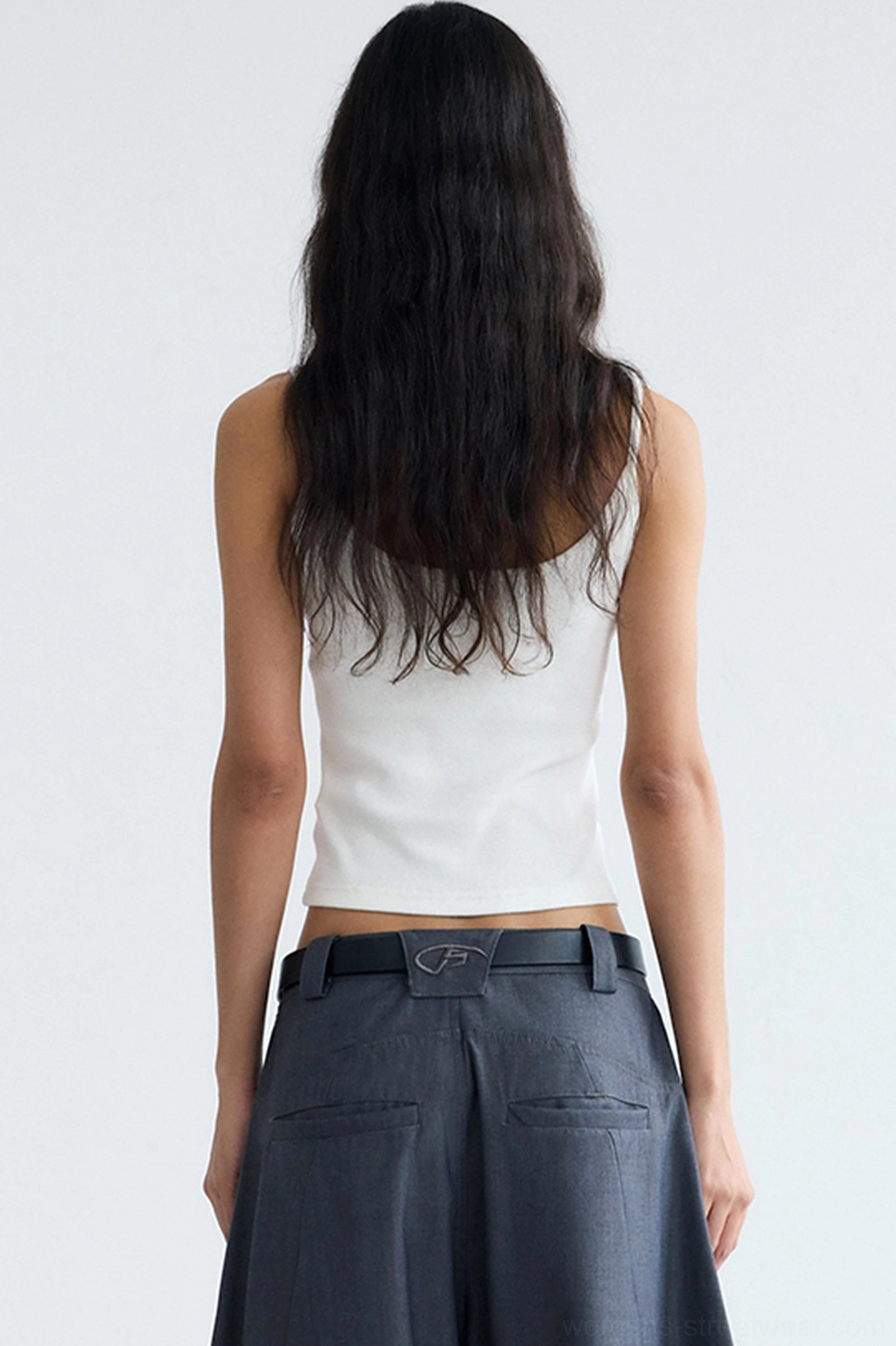 Back view of women's white cropped camisole tank top with slim fit and simple minimalist streetwear design