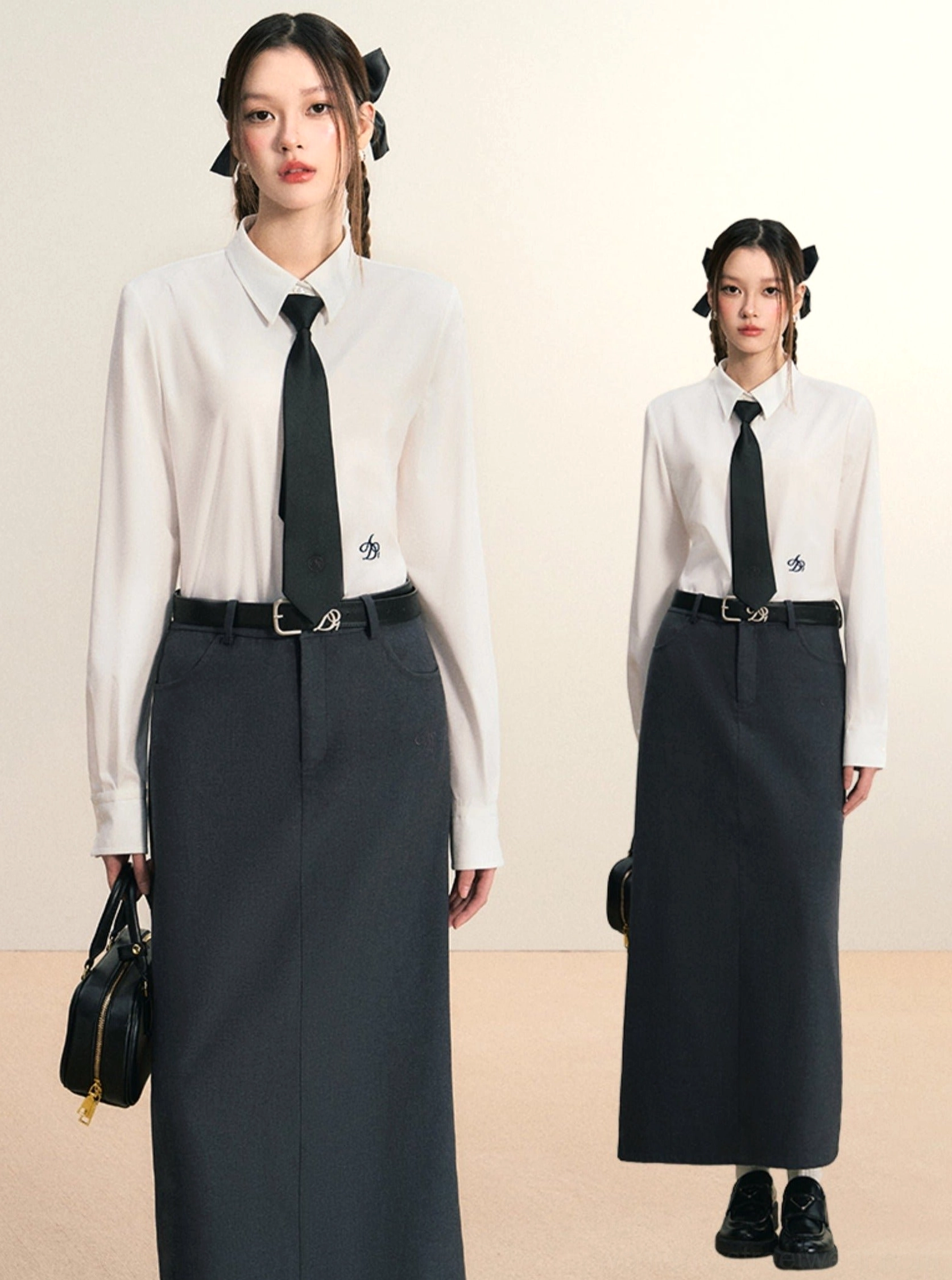 White women's button down shirt with black tie and long dark skirt in Korean academic streetwear styling