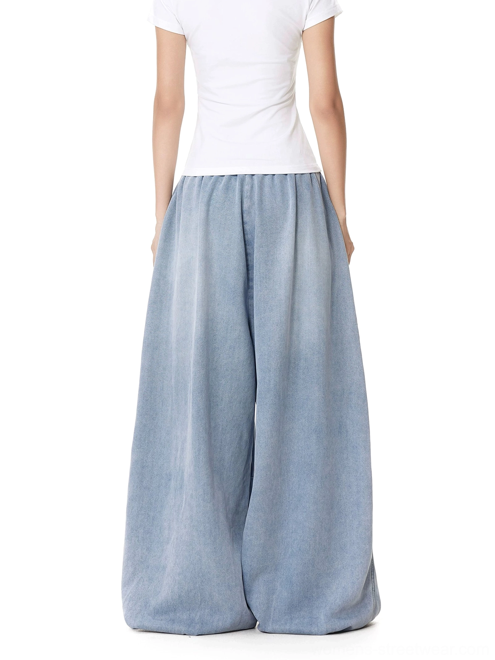 Back view of women's light blue wide-leg drawstring jeans showing the elasticated back waist, relaxed full-leg silhouette, and flowing baggy fit