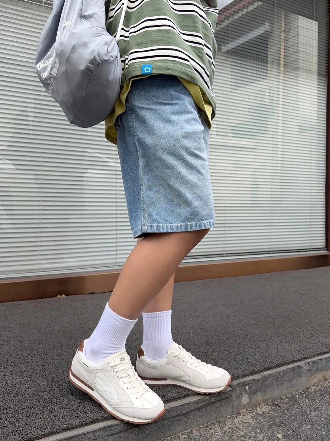 Women's wing panel retro court sneakers with gum sole styled with denim shorts for a relaxed casual streetwear look