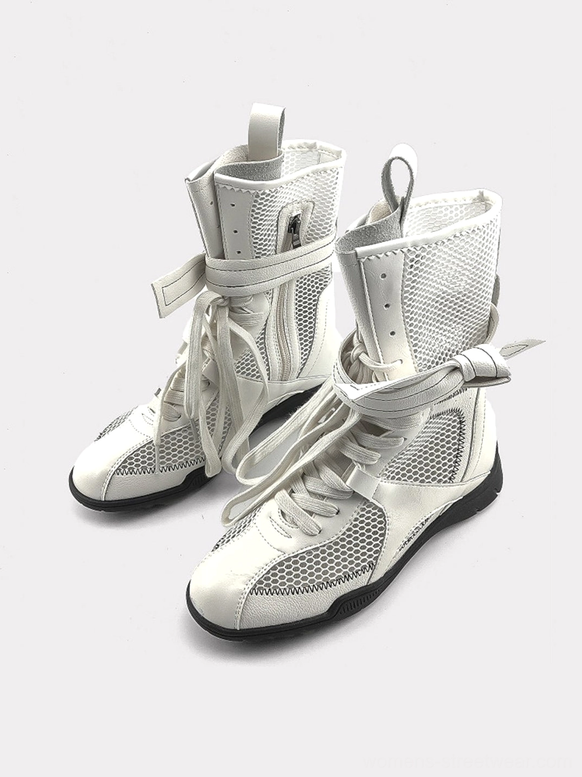 Pair of white women's bow lace-up mesh mid-calf sport boots shown from a front three-quarter angle with round toes and layered ankle straps