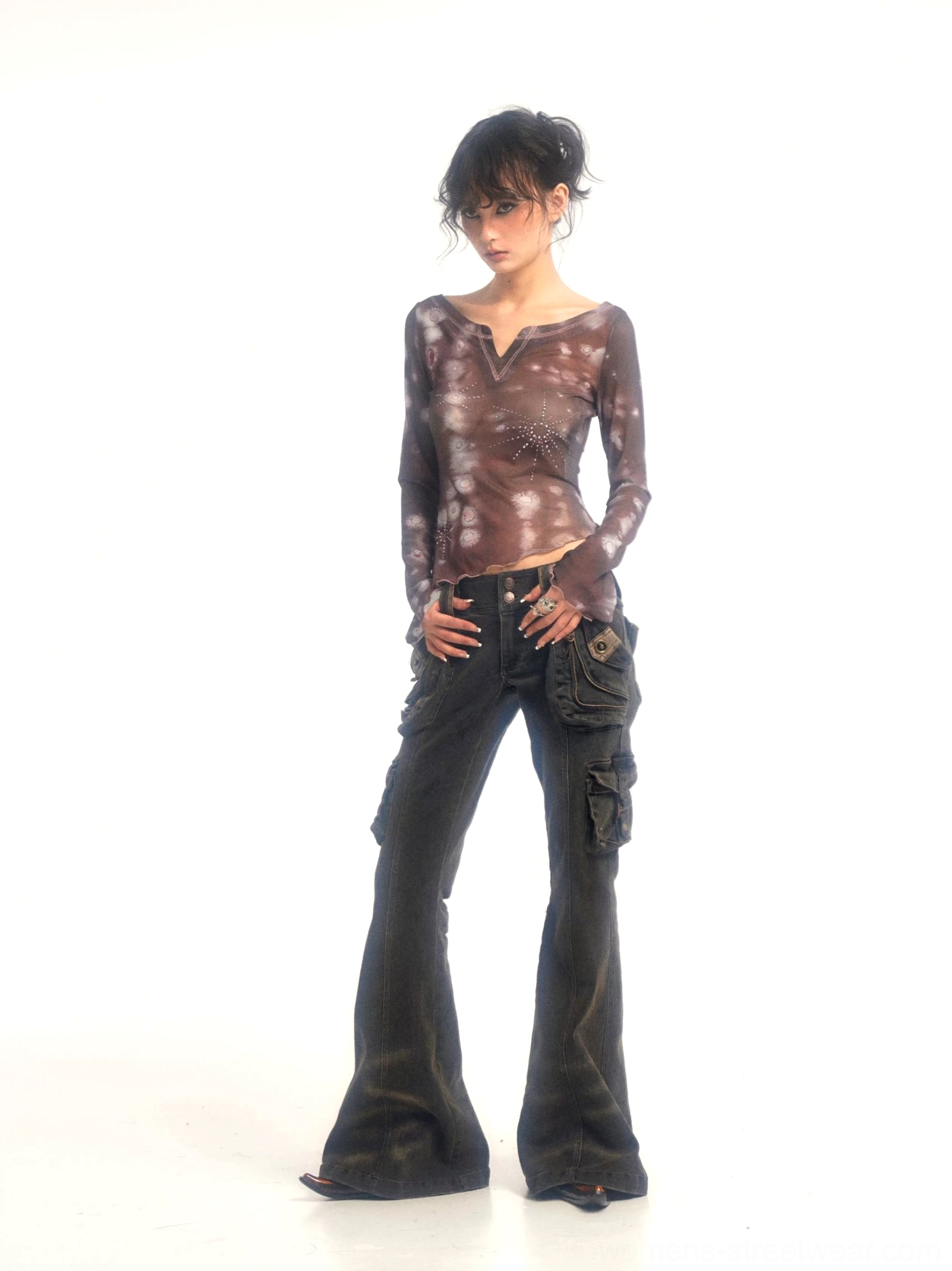 Front view of worn-style washed black cargo flare jeans with distressed fading, multiple pockets, and a dramatic wide flared leg