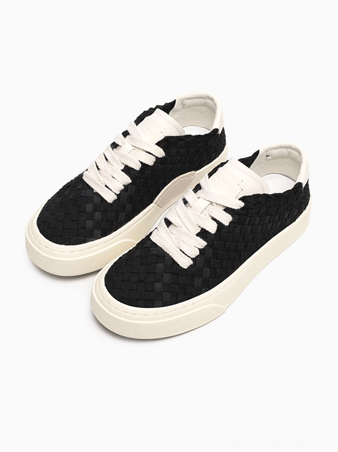 Black woven platform sneakers side three-quarter view showing thick contrast rubber platform sole