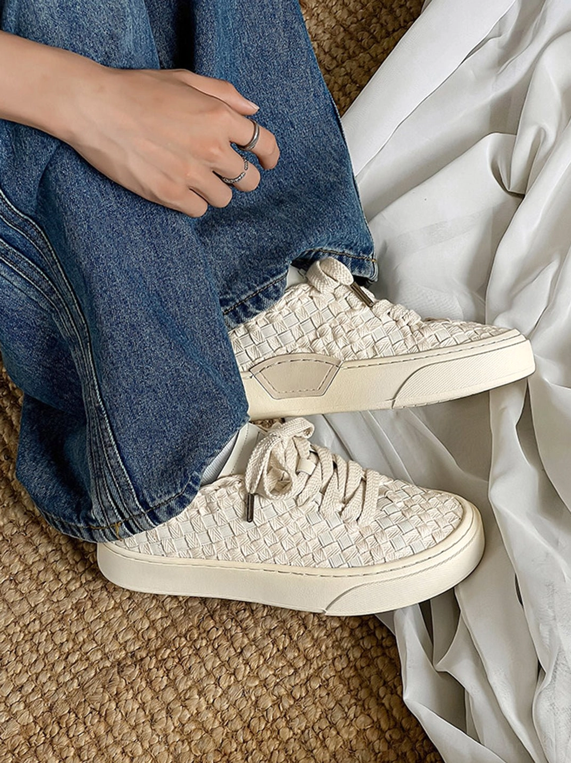 Woven platform sneakers close-up highlighting textured woven panels and structured rubber sole