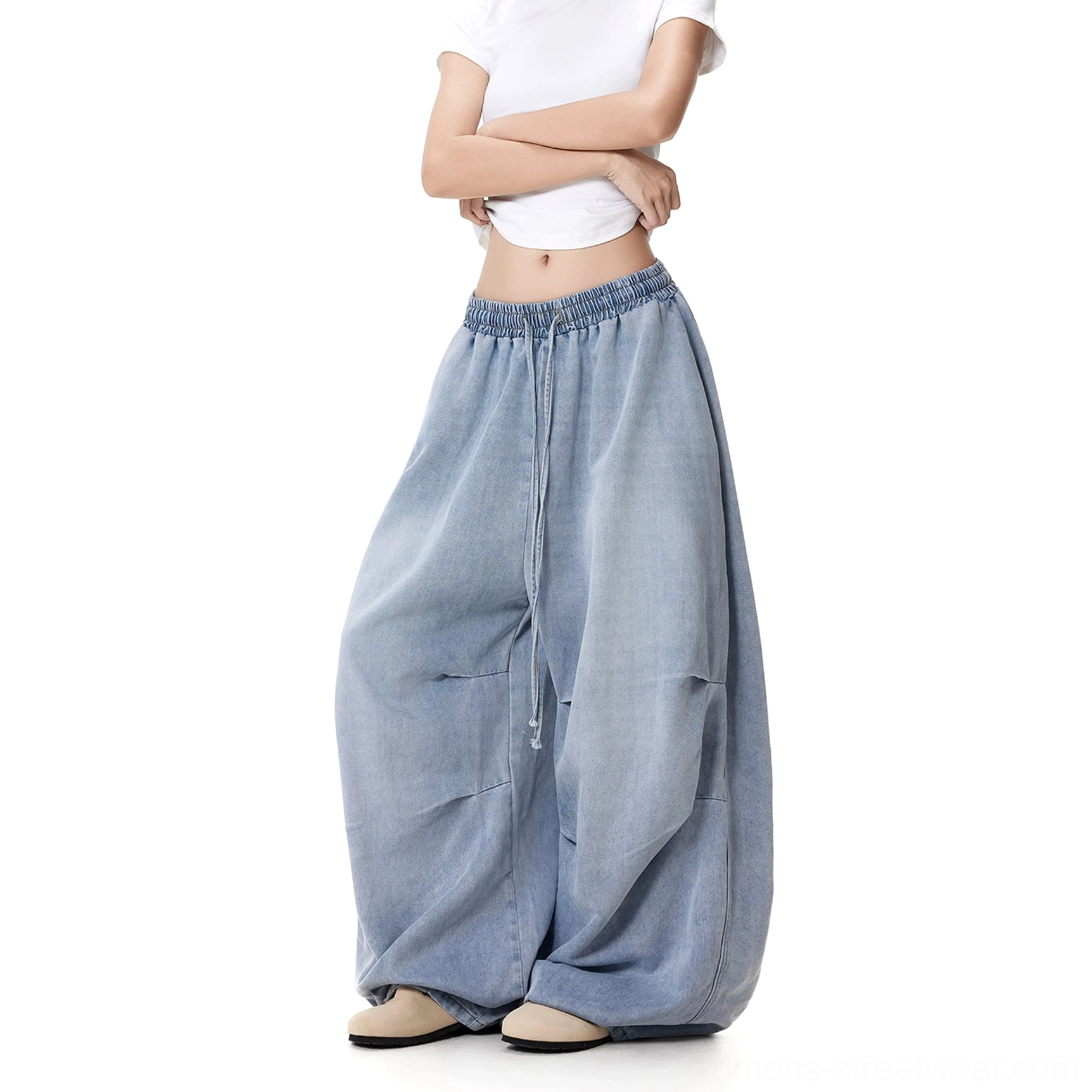Women's light blue wrinkled wide-leg drawstring jeans shown from a left three-quarter angle with oversized baggy legs and a relaxed streetwear silhouette
